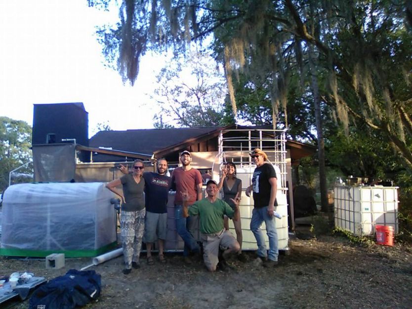 People standing next to Homebiogas system