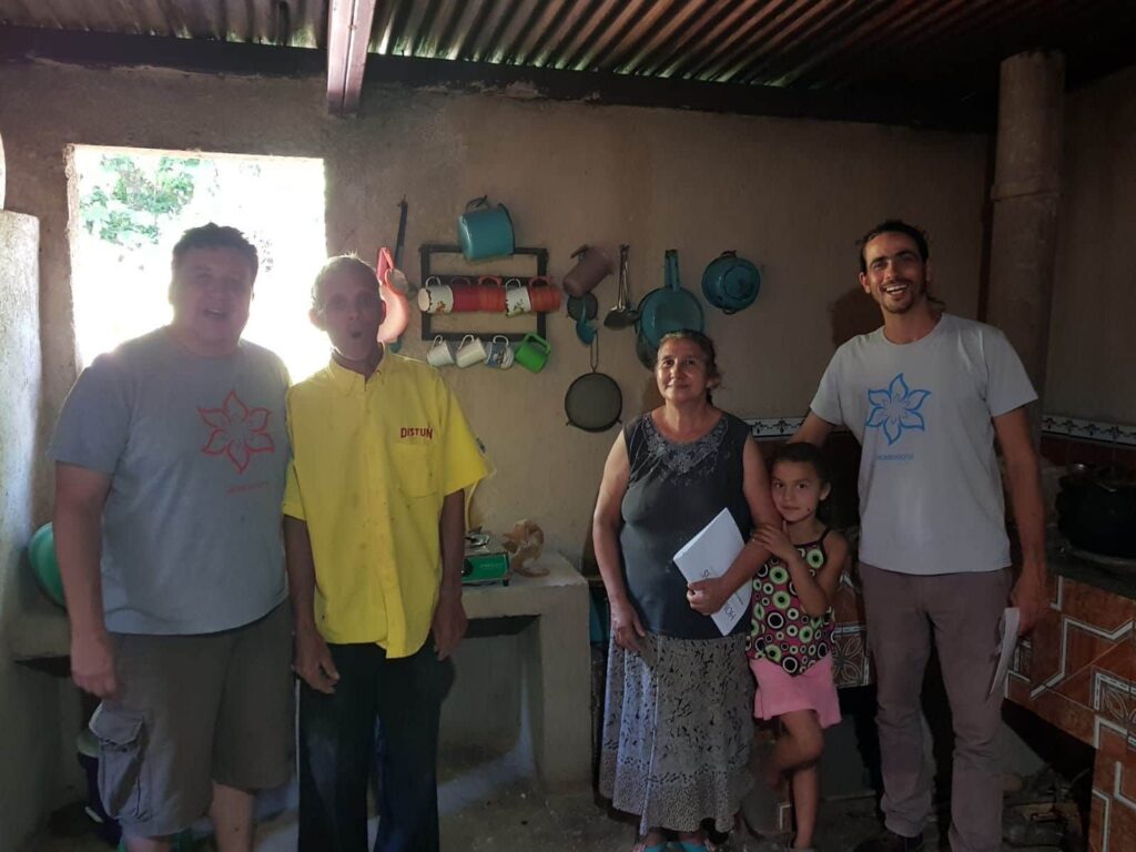 A family in a kitchen with Homebiogas stove in Guatemala